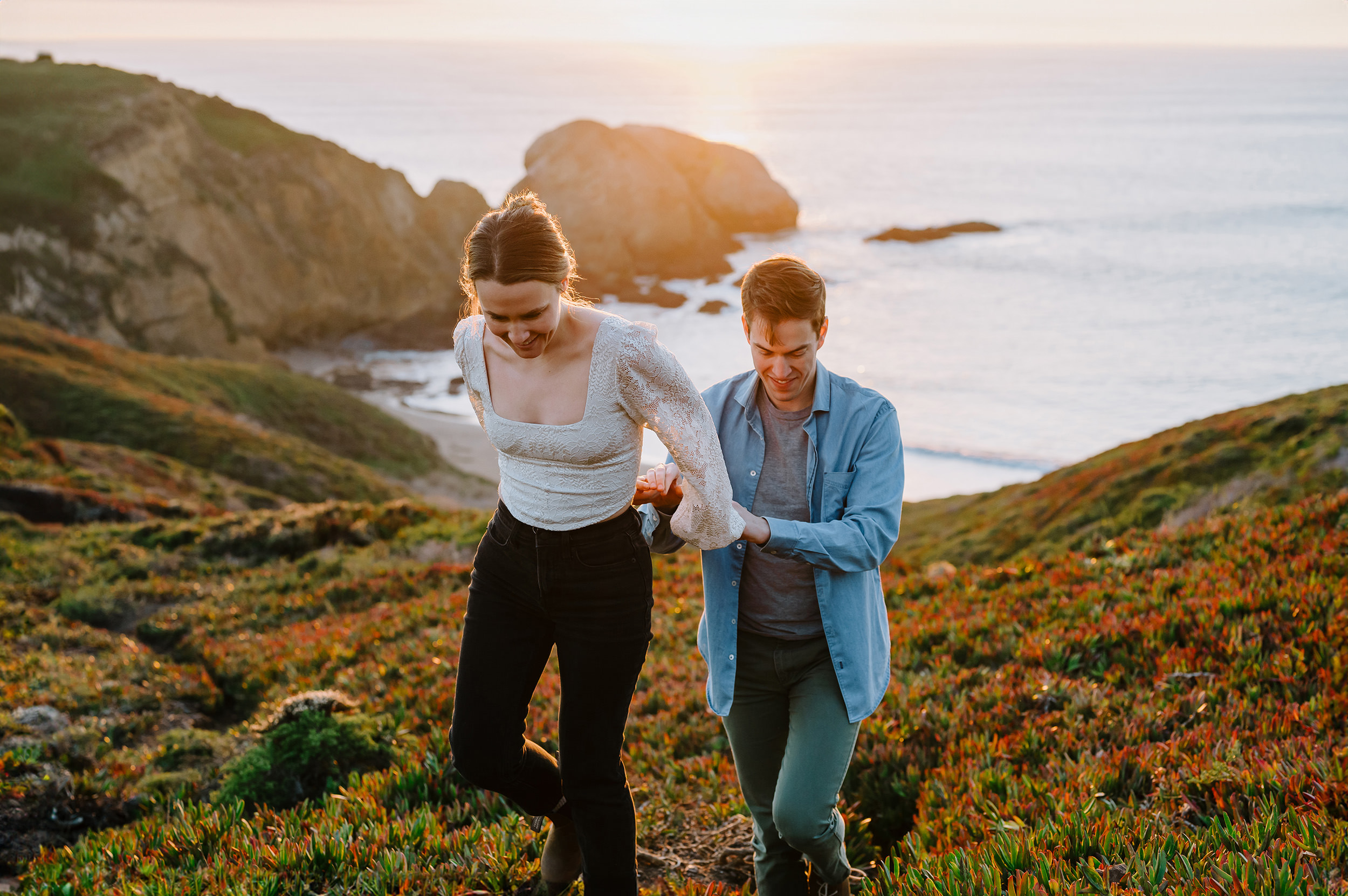 couple hiking for their engagement session at the Marin headlands at sunset